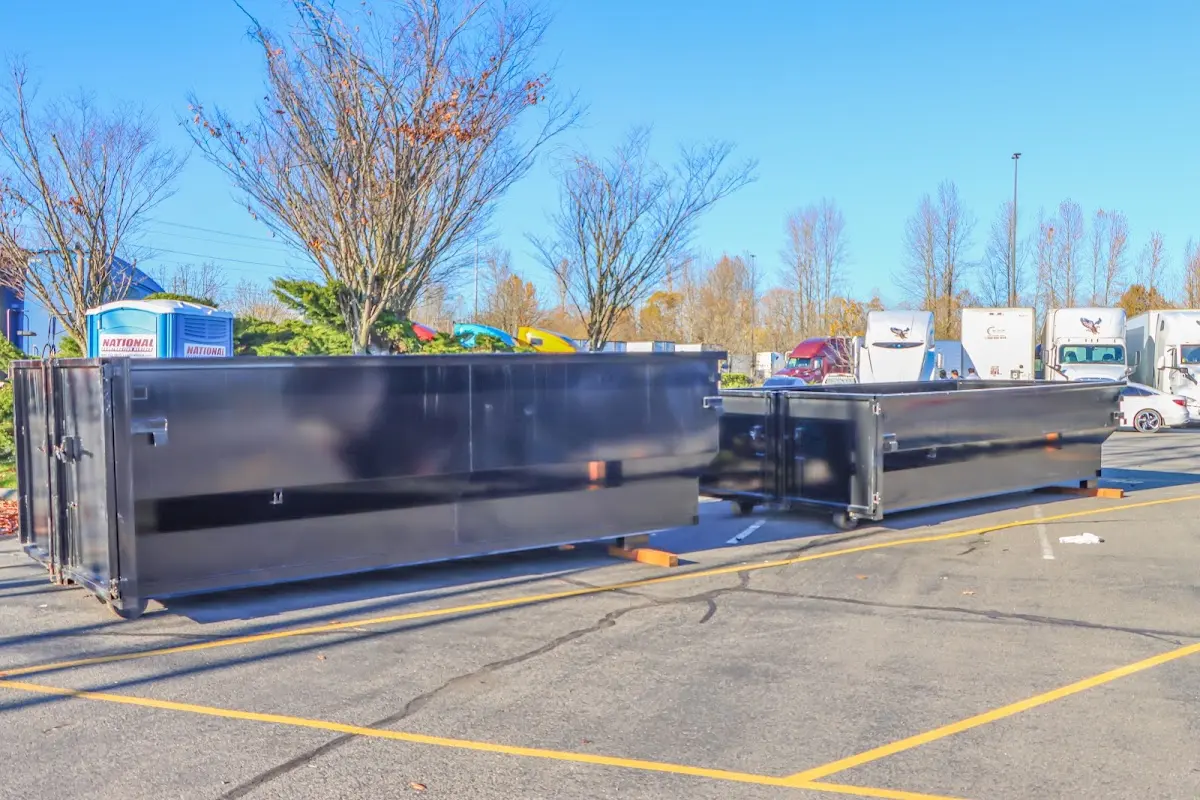 Professional dumpster rental service with roll-off container on residential driveway in Edgemere